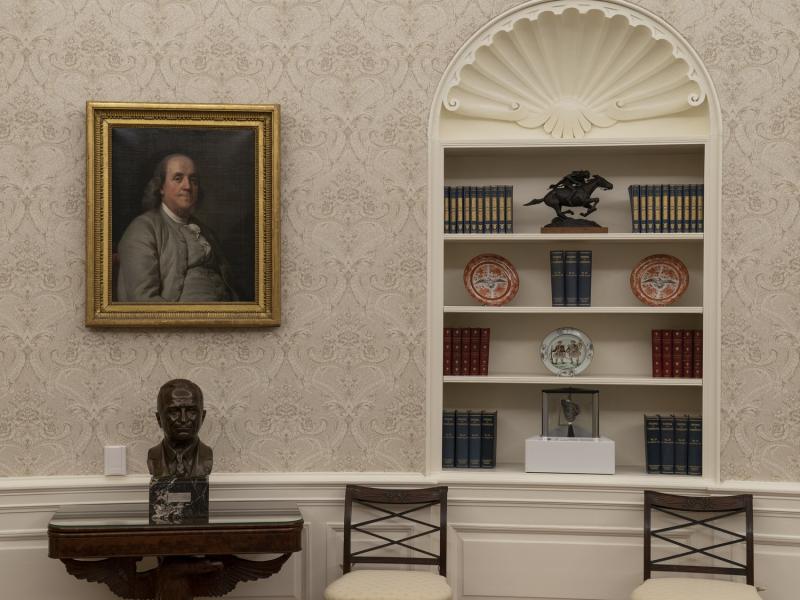 A moon rock is displayed on a bookshelf in the Oval Office.