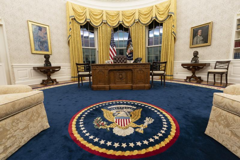 Biden kept the drapes and most of the furniture, but the rug and artwork in the Oval Office have changed. Flanking the Resolute desk are busts of Abraham Lincoln (left) and Harry Truman. Above Lincoln is The Avenue in the Rain by Childe Hassam. Above Truman is a portrait of Benjamin Franklin.