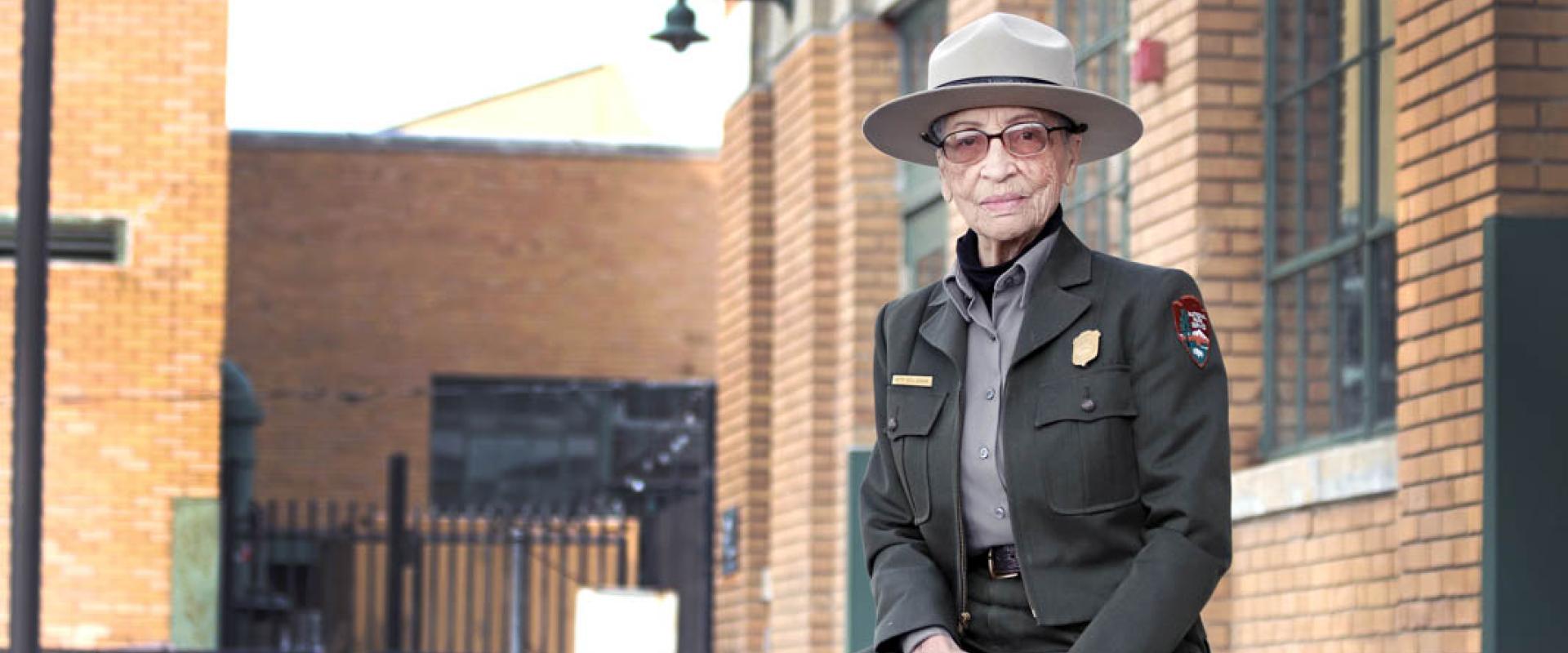 Ranger Betty Reid Soskin sits in front of the Rosie the Riveter Visitor Center. She is 96 years old. (Luther Bailey/NPS)