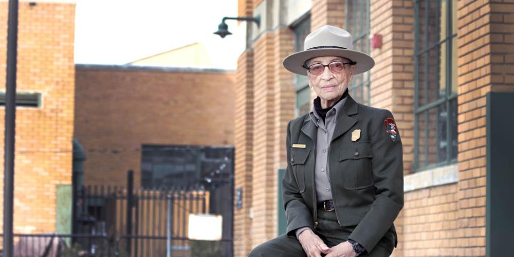Ranger Betty Reid Soskin sits in front of the Rosie the Riveter Visitor Center. She is 96 years old. (Luther Bailey/NPS)