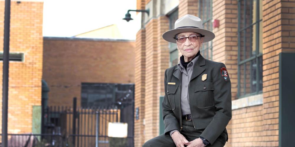 Ranger Betty Reid Soskin sits in front of the Rosie the Riveter Visitor Center. She is 96 years old. (Luther Bailey/NPS) Ranger Betty Reid Soskin sits in front of the Rosie the Riveter Visitor Center. She is 96 years old. (Luther Bailey/NPS)